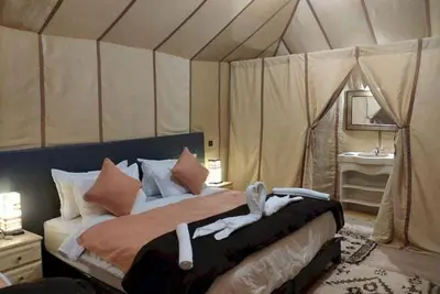 a bedroom with a bed in a tent at enjoy best night in desert merzouga in Merzouga