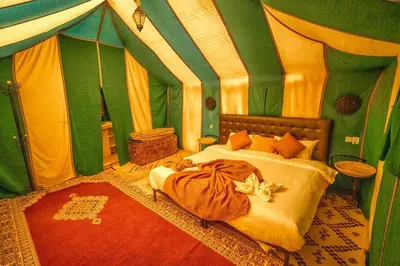 a bedroom with a bed in a tent at enjoy best night in desert merzouga in Merzouga