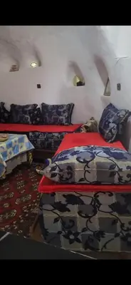 a bedroom with two beds in a room at Yamna Cozy Cave in Bhalil