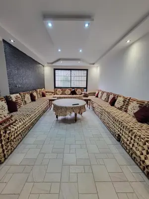 a large waiting room with couches and a table at Villa Enouzha in Fès