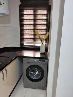 a washing machine in a kitchen with a window at Apartment Sea view Toudert Anza Agadir in Oulad Akkou