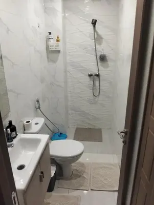 a bathroom with a shower and a toilet and a sink at Apartment Sea view Toudert Anza Agadir in Oulad Akkou