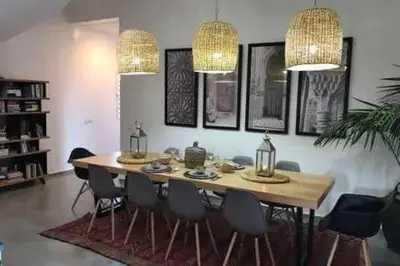 a dining room with a wooden table and chairs at Villa Roseaux heated pool Marrakech in Najem