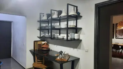 a shelf with plates and dishes on a wall at Villa Roseaux heated pool Marrakech in Najem