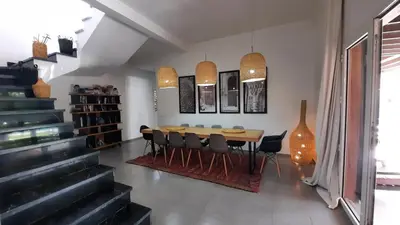a dining room with a wooden table and chairs at Villa Roseaux heated pool Marrakech in Najem