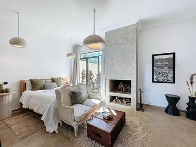 a bedroom with a bed and a fireplace at Villa Paschmina, petit-déjeuner inclus in Ourika