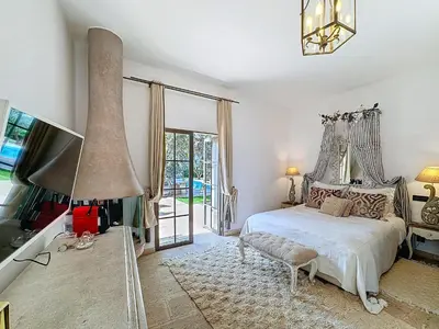 a bedroom with a bed and a large window at Villa Paschmina, petit-déjeuner inclus in Ourika