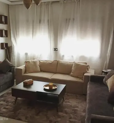 a living room with a couch and a coffee table at Smart home oumnia in Fès