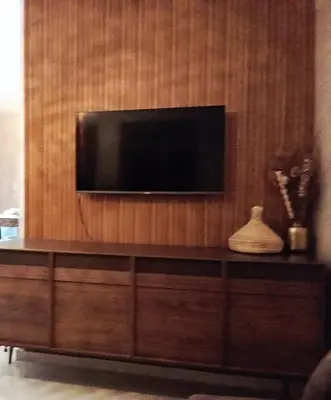 a flat screen tv on a wooden wall at Smart home oumnia in Fès