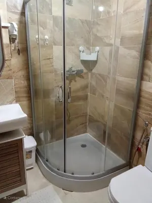 a shower with a glass door in a bathroom at Smart home oumnia in Fès