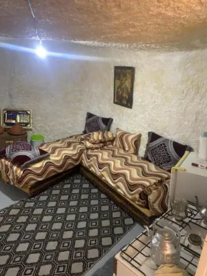 a living room with a couch in a room at كهوف يحيى لسياحة والمبيت البهاليل in Bhalil