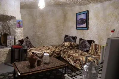 a living room with a couch and a table at كهوف يحيى لسياحة والمبيت البهاليل in Bhalil