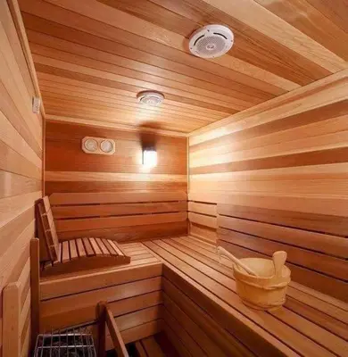 a wooden sauna with a bench and a bucket in it at sale in Oulad Akkou