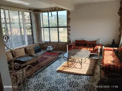 a living room with a couch and a table at Authentic Guesthouse with Garden and Mountain View Beni Mellal in Beni Mellal