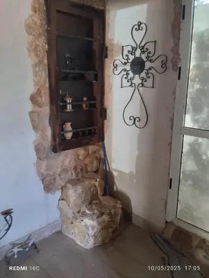 a corner of a room with a stone wall at Authentic Guesthouse with Garden and Mountain View Beni Mellal in Beni Mellal