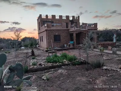 a house in the middle of a field at Authentic Guesthouse with Garden and Mountain View Beni Mellal in Beni Mellal