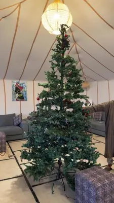 a christmas tree in a living room at Aurora Dunes Camp in Merzouga