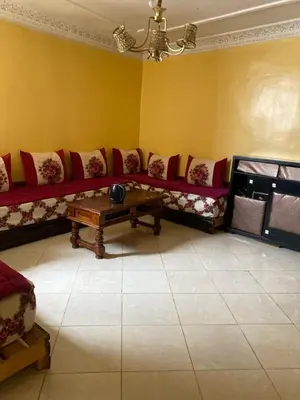 a living room with a couch and a coffee table at مكناس مريم in Meknès