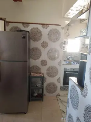 a kitchen with a stainless steel refrigerator and a stove at مكناس مريم in Meknès