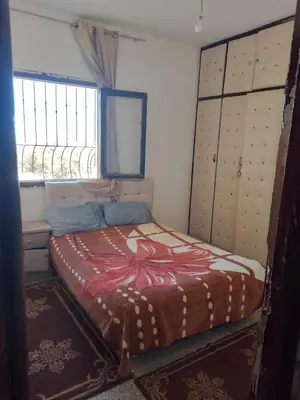 a bedroom with a bed in a room with windows at مكناس مريم in Meknès