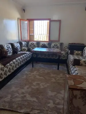 a living room with couches and a window at مكناس مريم in Meknès