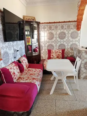 a living room with a couch and a table at مكناس مريم in Meknès