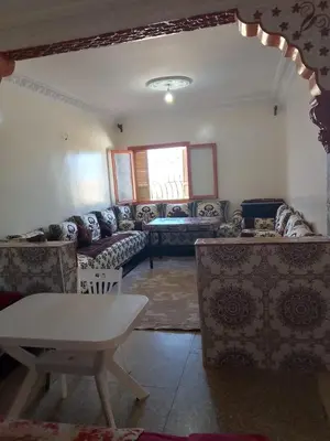 a living room with couches and a table at مكناس مريم in Meknès