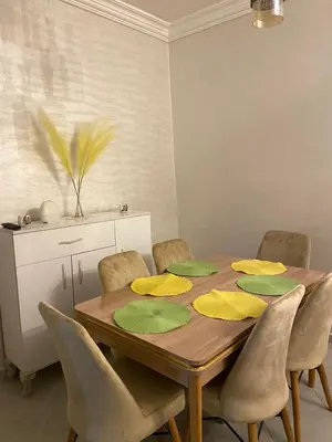 a dining room table with yellow and green napkins on it at Joude in Fès