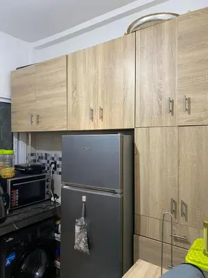 a kitchen with a refrigerator and wooden cabinets at Joude in Fès