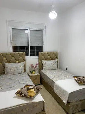 a bedroom with two beds and a window at Joude in Fès