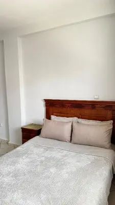 a bedroom with a large bed with two pillows at Appartement spacieux à Agadir in Oulad Akkou