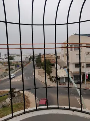 a view of a city street from a window at Appartement spacieux à Agadir in Oulad Akkou