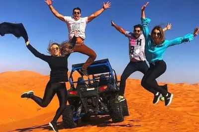 a group of people jumping in the desert at luxury desert night camp in Merzouga