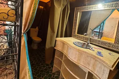 a bathroom with a sink and a mirror at luxury desert night camp in Merzouga