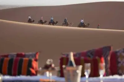 a shelf with jockeys riding horses in a horse race at luxury desert night camp in Merzouga