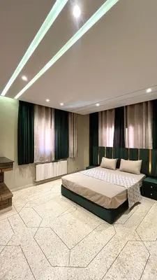 a bedroom with a large bed and a piano at Appartement Al Arz Atlas in Ifrane