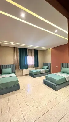 a room with three beds in a room at Appartement Al Arz Atlas in Ifrane
