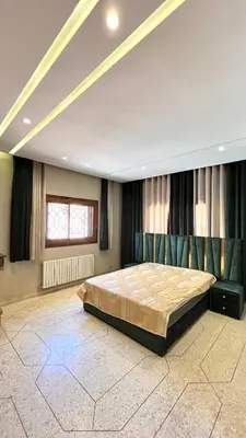 a bedroom with a large bed in a room at Appartement Al Arz Atlas in Ifrane