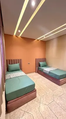 two beds are sitting in a room at Appartement Al Arz Atlas in Ifrane