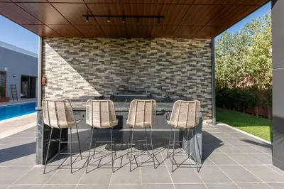 a group of chairs sitting around a table on a patio at Villa Ramona, Calme, Luxe et Piscine in Marrakech