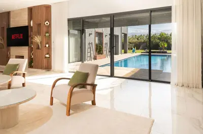 a living room with a pool and a table and chairs at Villa Ramona, Calme, Luxe et Piscine in Marrakech