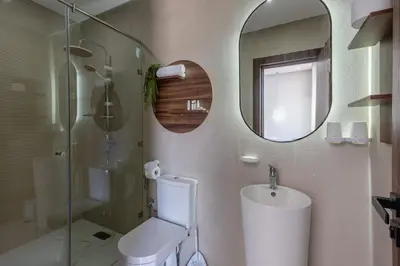a bathroom with a toilet and a sink and a mirror at Villa Ramona, Calme, Luxe et Piscine in Marrakech