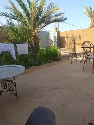 a group of chairs and tables and a table and chairs at Dar Bafdil in Kasr Bounou