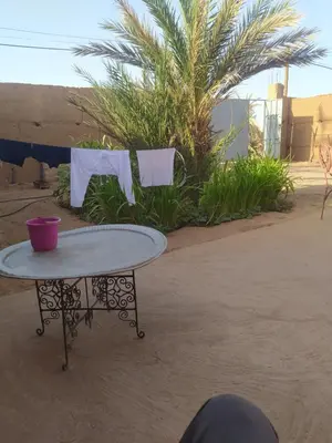 a table with a purple bowl on top of it at Dar Bafdil in Kasr Bounou