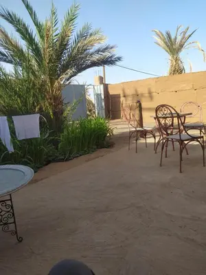 a group of chairs and tables on a patio at Dar Bafdil in Kasr Bounou