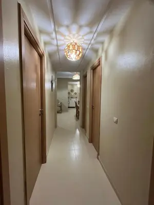 a corridor of a hallway with a light fixture at Appartement de 3 chambres pour 6 voyageurs à 20 minutes de centre ville de Marrakech in Azib Oulad Lâdem