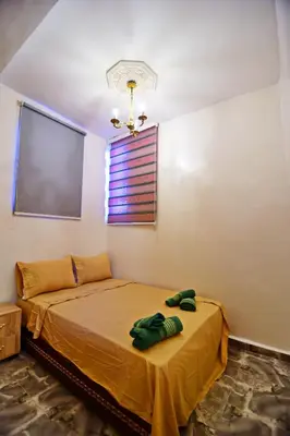 a bedroom with a bed in a room with a window at DAR El Ghali in Fès