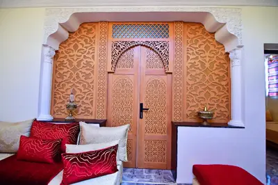 a room with a door with red and white pillows at DAR El Ghali in Fès