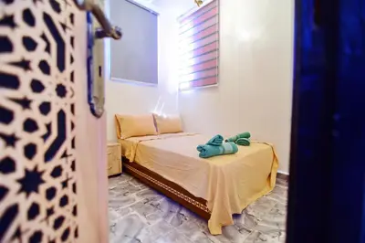 a bedroom with a bed with a teddy bear on it at DAR El Ghali in Fès