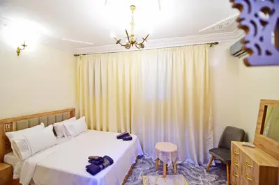 a bedroom with a bed and a chandelier at DAR El Ghali in Fès